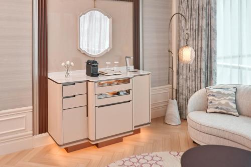 a dressing table in a room with a chair and a mirror at The St. Regis Singapore in Singapore