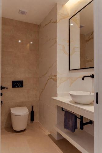 a bathroom with a sink and a toilet at Nusa Apartments Monte Cara in Mindelo