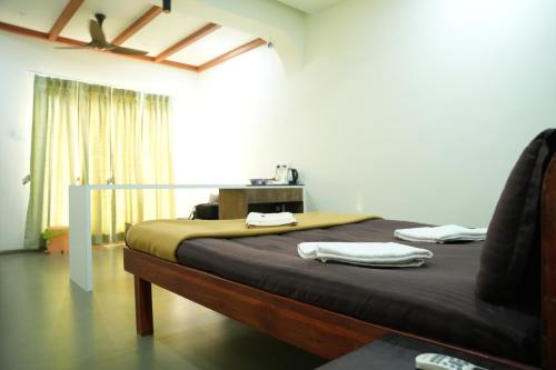 a bedroom with a large bed with at Konkantrip Beach Resort in Dapoli