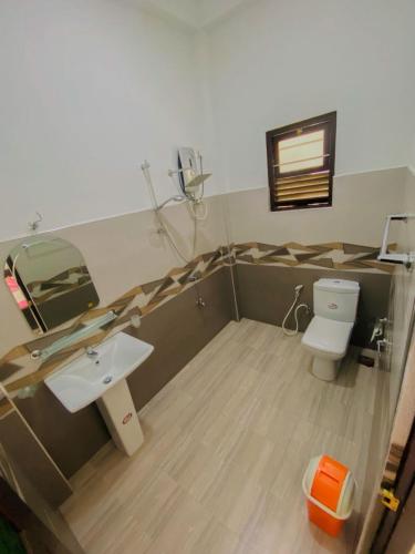 a bathroom with a sink and a toilet at Green Haven Yala Safari Retreat in Tissamaharama