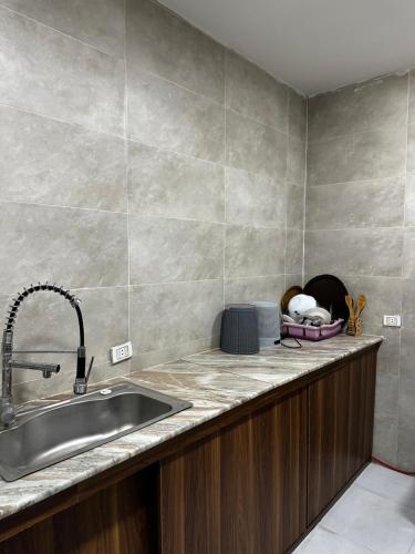 a kitchen with a sink and a counter at villa 578 in Sheikh Zayed