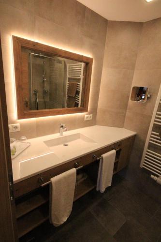 a bathroom with a sink and a mirror at Haus Dorfblick in Gerlos