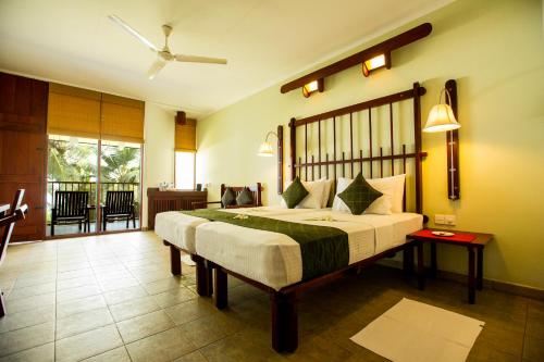 a bedroom with a large bed in a room at Koggala Beach Hotel in Koggala