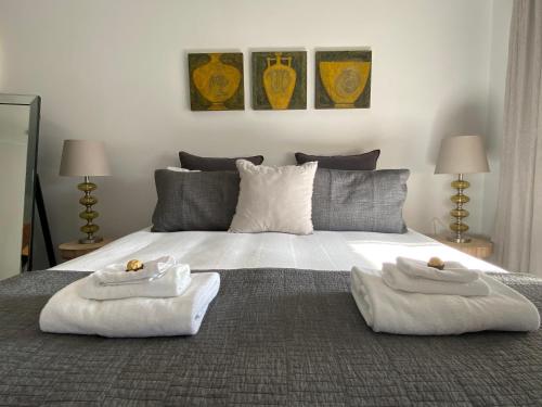a bedroom with two towels on a bed at Downtown, Contemporary and Artistic in Albany