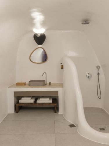 a white bathroom with a sink and a tub at Aspaki by Art Maisons in Oia