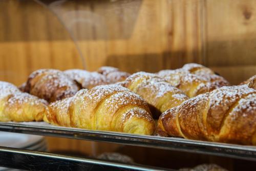 a bunch of pastries in a display case in a bakery at Hotel Max in Aversa