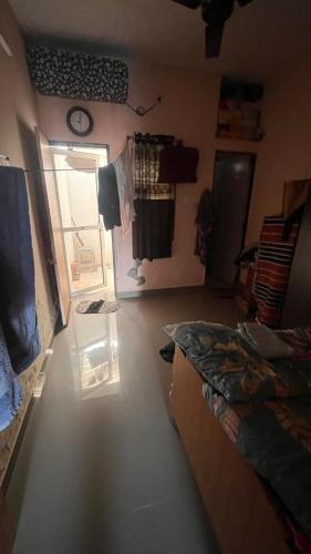 a room with a bedroom with a bed and a door at Madhuram Township in Jamnagar