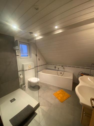 a bathroom with a tub and a toilet and a sink at Münsterblick in Wolframs-Eschenbach