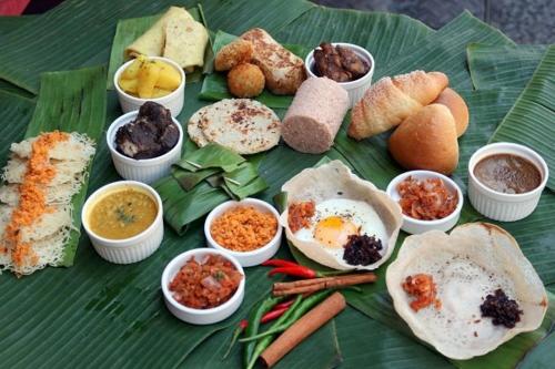 a green table with different types of food on it at River cottage Demodara in Demodera