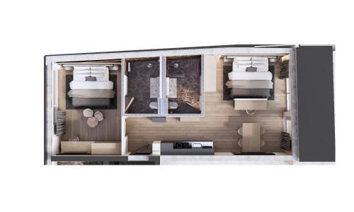 een plattegrond van een kleine kamer met twee bedden bij Chalet Ischgl - Modern Luxury Residences in Ischgl