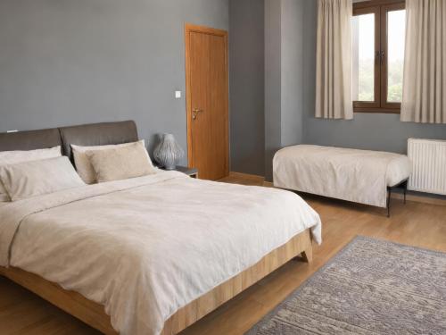 a bedroom with two beds and a window at Filia Garden in Samos