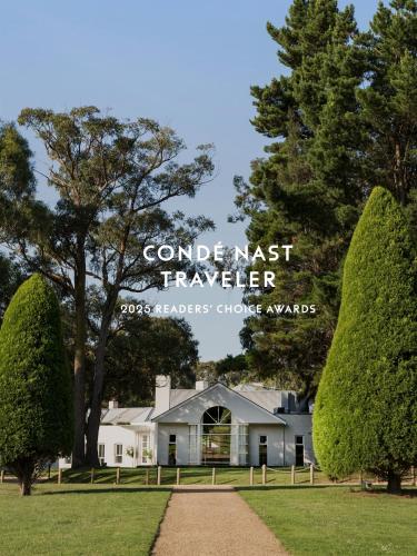 a white house with trees in front of it at Lancemore Lindenderry Red Hill in Red Hill