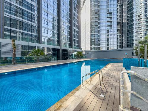 a swimming pool with tall buildings in the background at Full Sunset Canal Views - Amazing Apartment in the Heart of Al Reem - 5 min from Cleveland, Galleria, ADGM in Abu Dhabi
