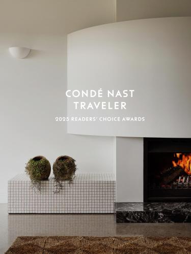 a fireplace in a living room with two plants on it at Lancemore Milawa in Milawa