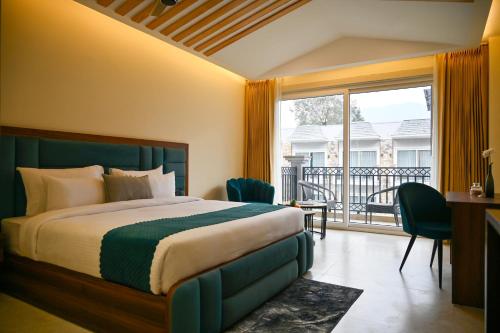 a hotel room with a bed and a balcony at Amritara Chakra River Resort - Closest Luxury Resort to Neelkanth Temple in Mohan Chatti