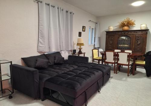 a living room with a couch and a dining room at Chalet antiguo reformado "El Mirador" in Hoyo de Pinares