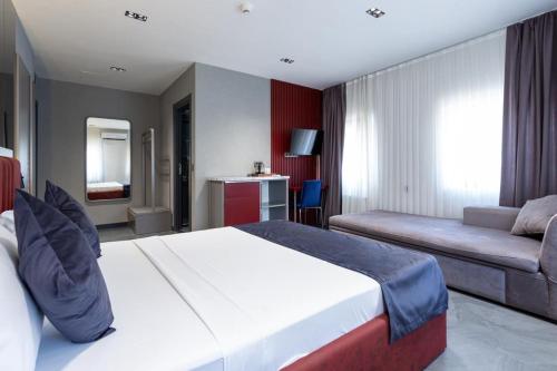 a hotel room with a bed and a couch at Abone Suites in Istanbul