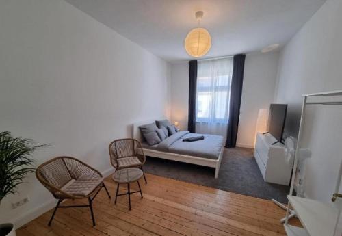 a living room with a couch and two chairs at Süße Marie 8 in Karlsruhe