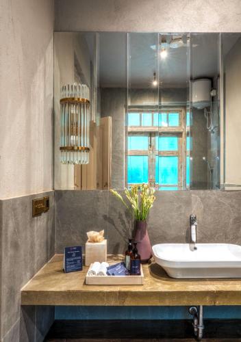 a bathroom with a sink and a counter with a mirror at LohonoStays Castello Villa 2 in Assagao