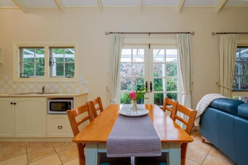 a dining room with a table and a blue couch at Big Brook Retreat in Pemberton