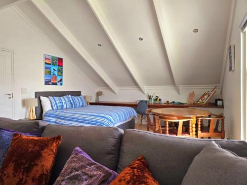 a living room with a couch and a bed at Penguin's at Sea in Grotto Bay