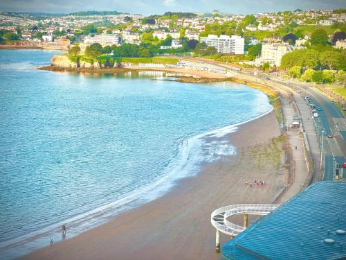 an aerial view of a beach and the ocean at Loveliest Homes Torquay - 3 bed, 2 bathroom, balcony, parking in Torquay