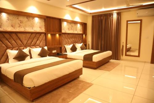 a hotel room with two beds in a room at Hotel Sahil Suites in Katra