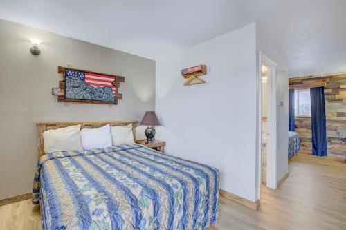 a bedroom with a bed with a colorful comforter at Bel Aire Motel Chamberlain Near Missouri River I 90 in Chamberlain
