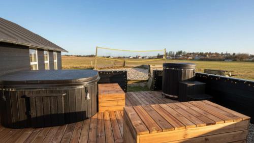 a wooden deck with two trash cans at Villavilla 637 - Vorupør, Nordjylland in Stenbjerg