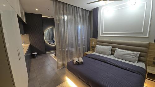 a bedroom with a large bed and a bathroom at Lake Side Drift by Luxury loft 37th floor in Noida