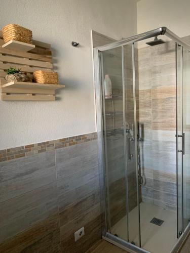 a shower with a glass door in a bathroom at Camera La Cinta in San Teodoro