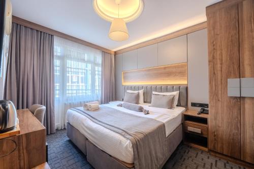 a hotel room with a large bed and a television at Best House Hotel OLD TOWN in Istanbul