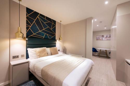 a bedroom with a large bed and a desk at NOX Golders Green in London