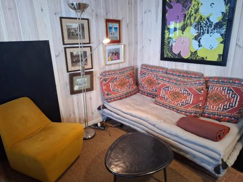 a living room with a couch and a chair at the hobbit house in Antwerp