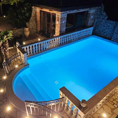 an empty swimming pool at night with lights at Casa Oasa Boutique rooms Pool near Koper in Koper