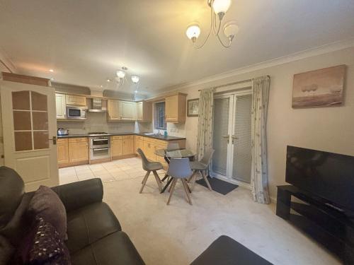 a living room with a couch and a kitchen at Bracknell Spacious Two Bedroom Apartment in Bracknell