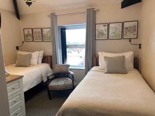 a bedroom with two beds and a window at Greylands Guest House in Llandrindod Wells