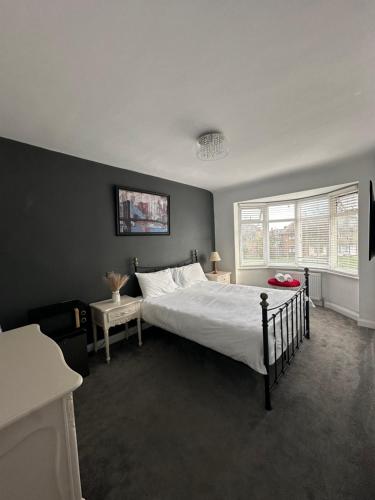a bedroom with a large bed and a window at Top House Sidcup in Streatham Hill