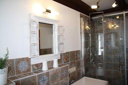 a bathroom with a sink and a mirror and a shower at Haus 68 Bergblick in Arrach