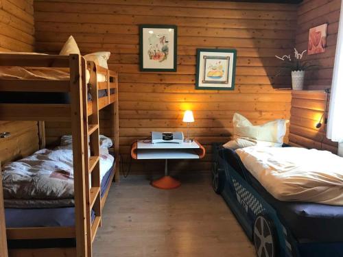 a bedroom with two bunk beds and a desk at Haus 68 Bergblick in Arrach