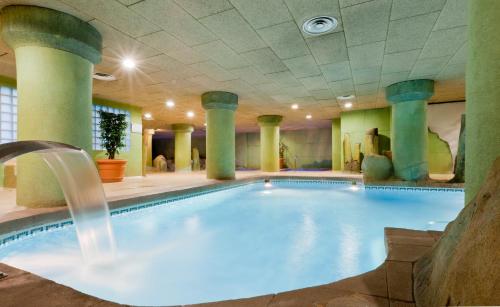 a pool in a hotel with a water fountain at Senator Granada in Granada