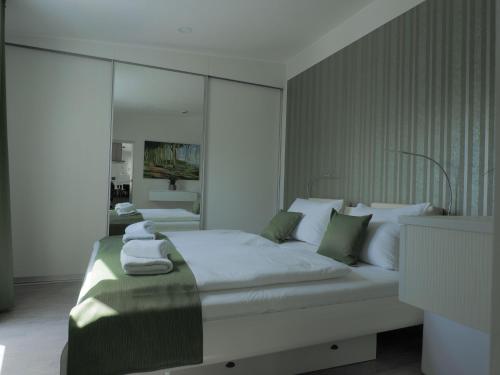 a bedroom with a large bed with towels on it at Kirchenplatz 6 Apartment 17 in Warnemünde