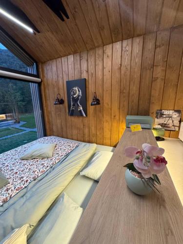 a room with a bed and a table with flowers on it at Trava Bungalow in Korostov