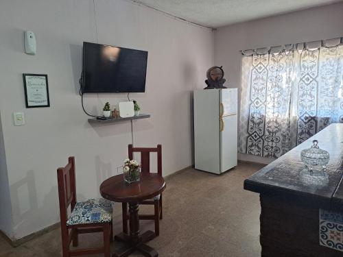 een keuken met een koelkast en een tafel en stoelen bij Alojamiento Marlugm in Corrientes