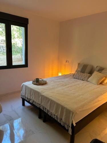 a bedroom with a large bed in a room at Résidence Les Jardins du Piale in Bonifacio