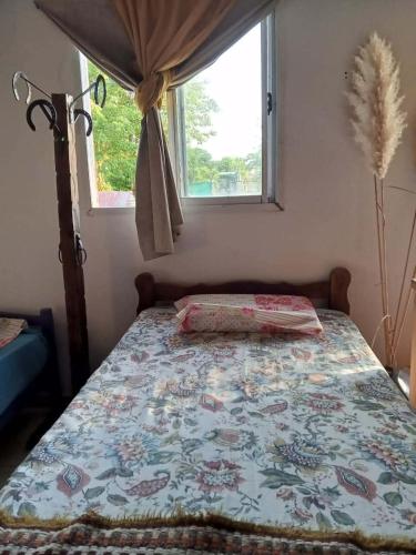 a bedroom with a bed with a quilt on it at La Marita in Gualeguay