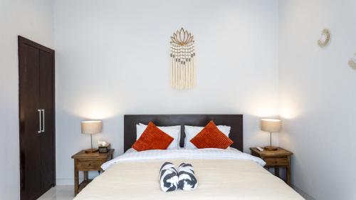 a bedroom with a large bed with orange pillows at 3BR Private Pool Villa in Central Seminyak - Walk to Cafés & Shops in Seminyak