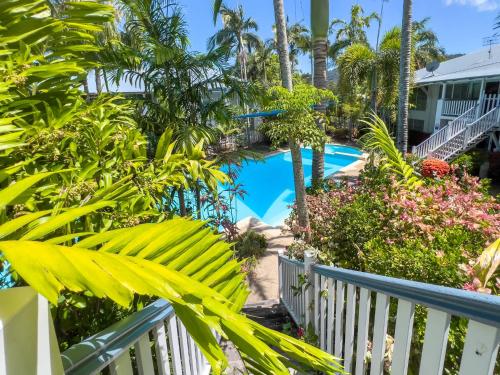 a view of the pool from the balcony of a resort at Escape To Mango House in Airlie Beach