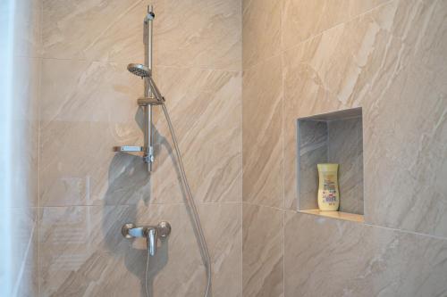 a shower in a bathroom with a glass door at Domaine de la batelle in Arles