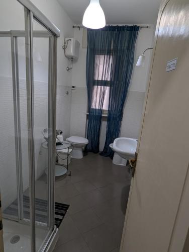 a bathroom with two toilets and a glass shower at Pearl Pisa guest house in Pisa